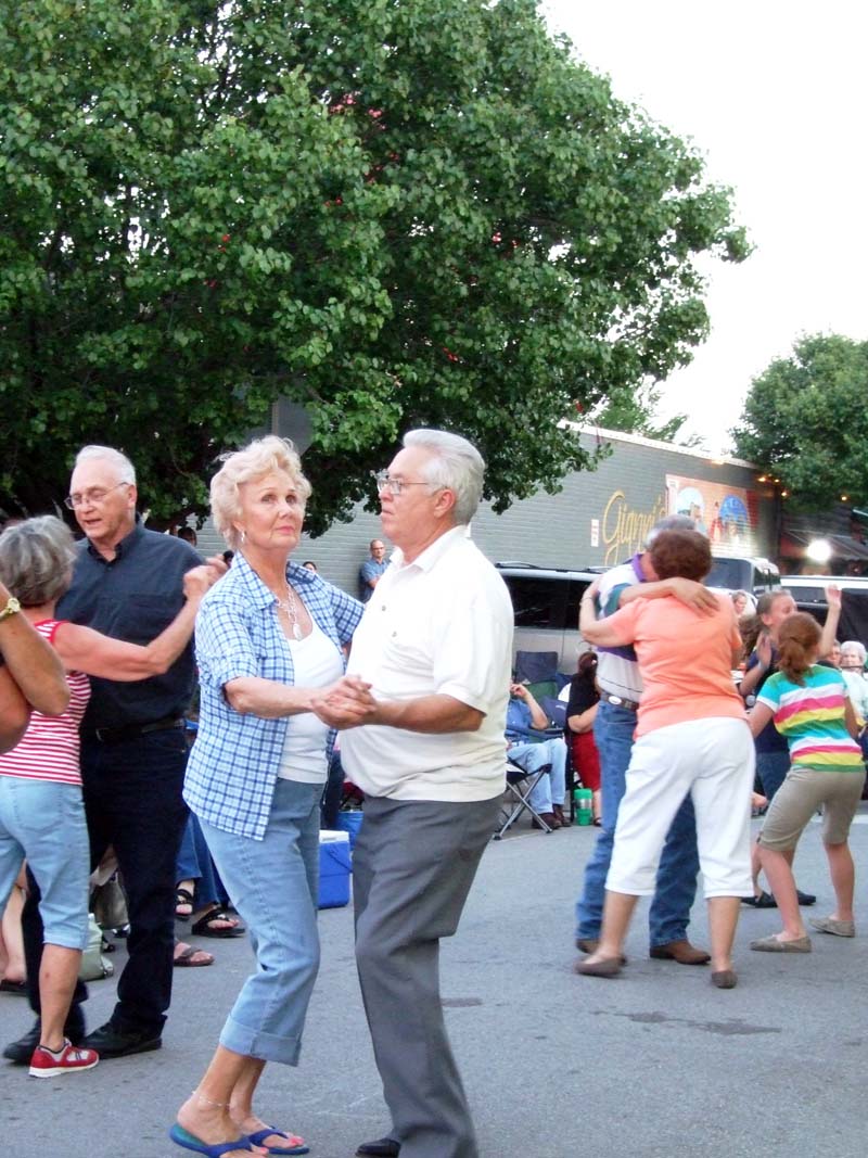 photo of people dancing to the music